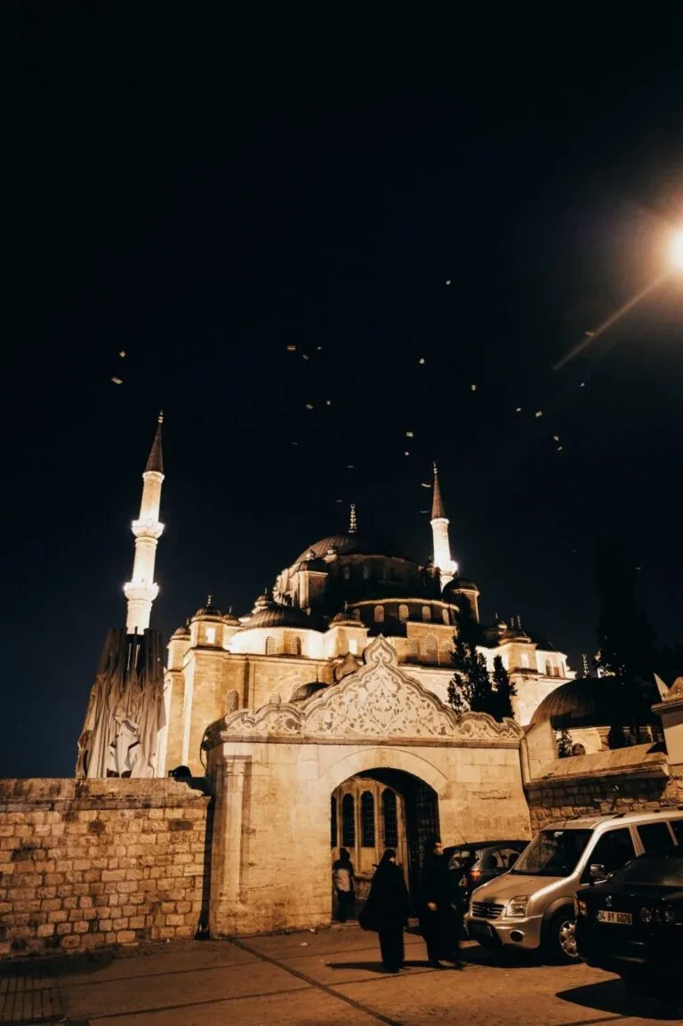 An illuminated mosque at night