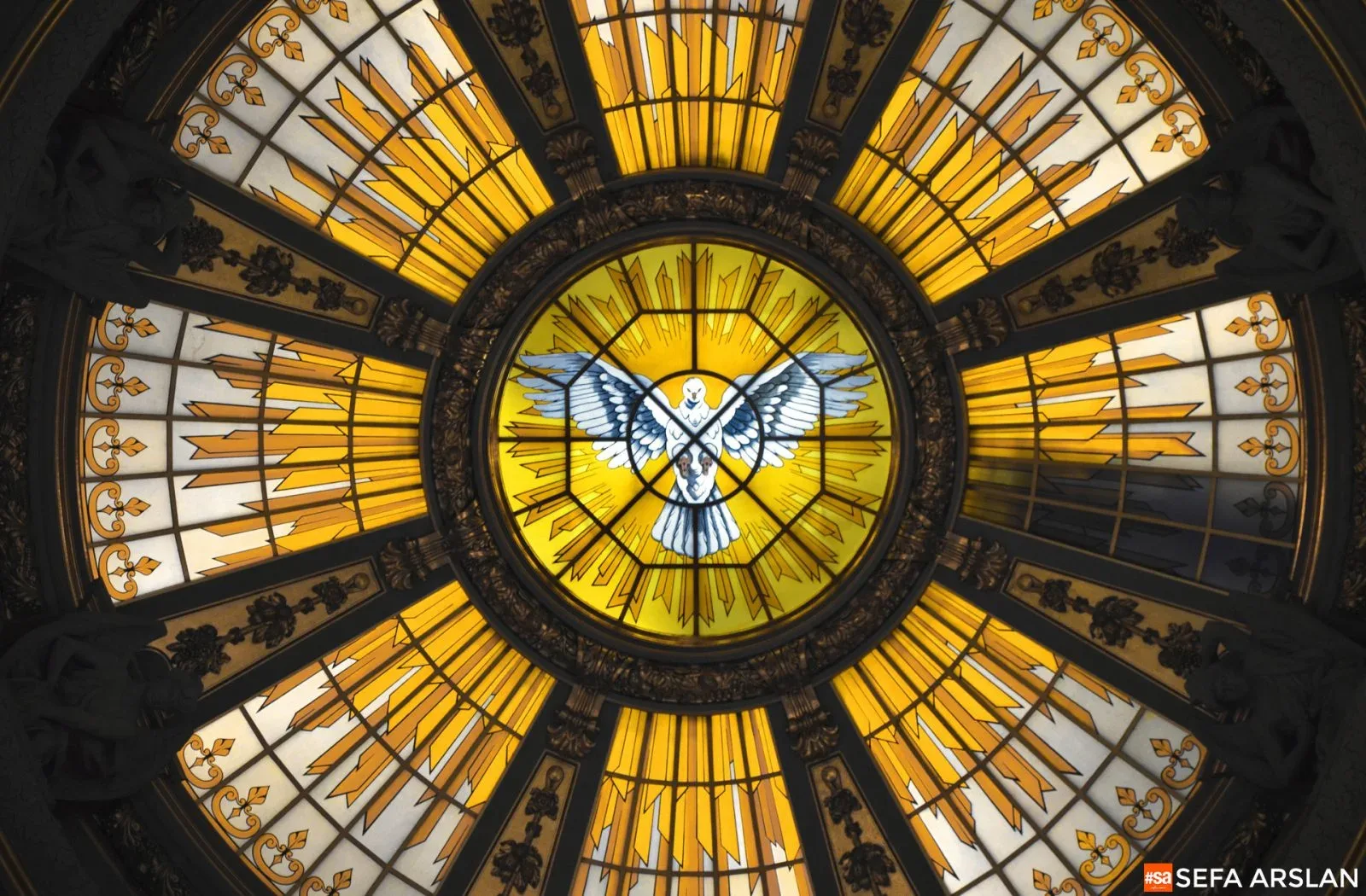 An ornate glass dome viewed from below