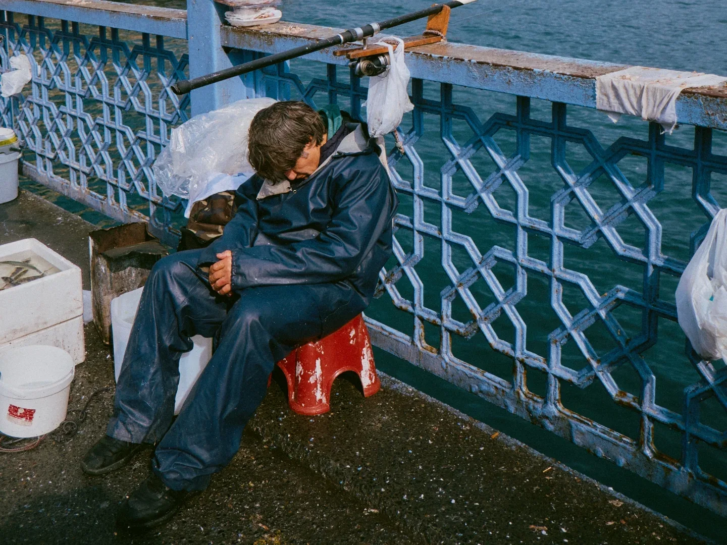 A fisherman asleep beside the water in Istanbul