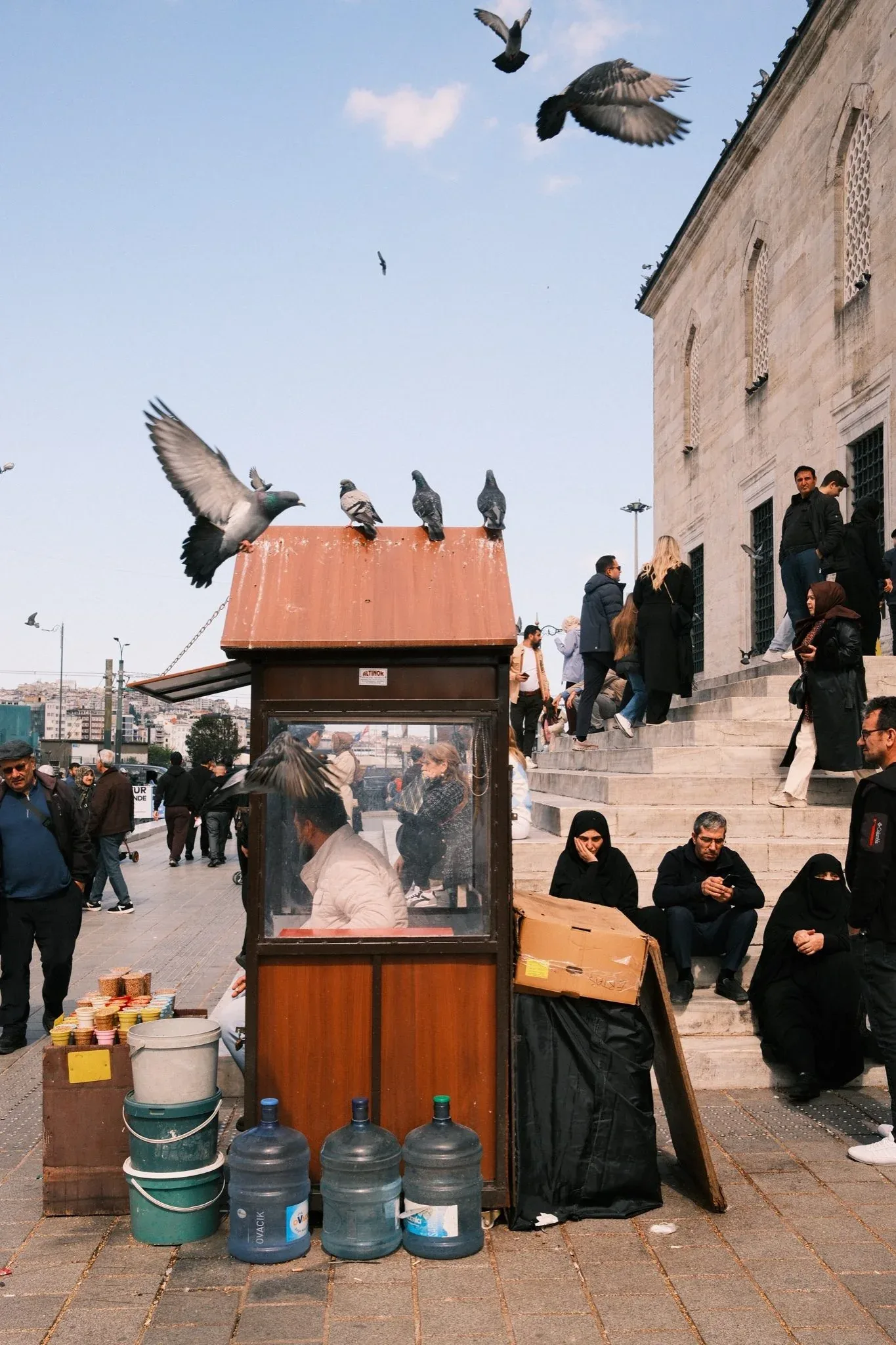 People gathered beside a pigeon shelter in Istanbul