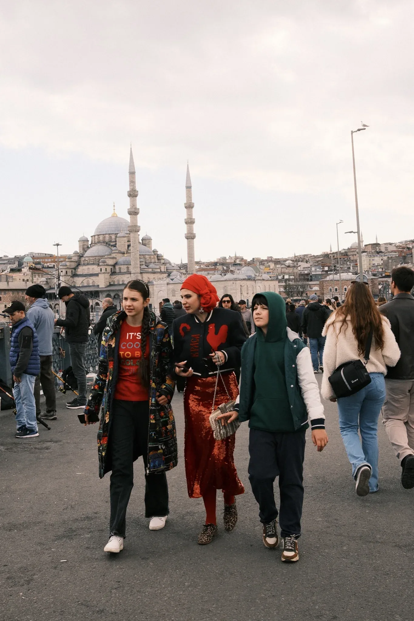 A woman in a red headscarf near Yeni Cami